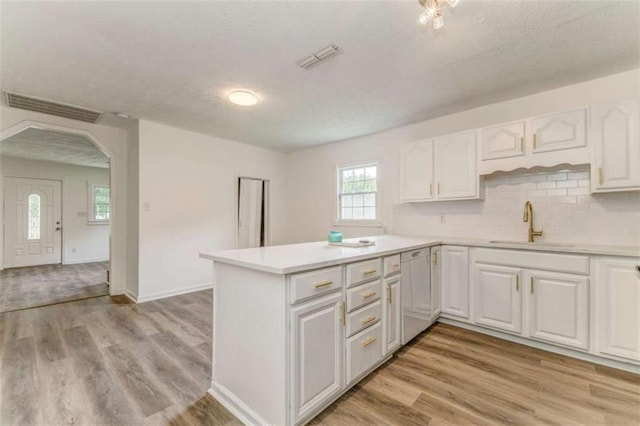 53 Knight Dr, Cedartown, GA 30125 - kitchen with arched walkways, white cabinets, a textured ceiling, a peninsula, and light countertops