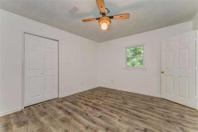 53 Knight Dr, Cedartown, GA 30125 - unfurnished bedroom with wood finished floors, a textured ceiling, a closet, and ceiling fan