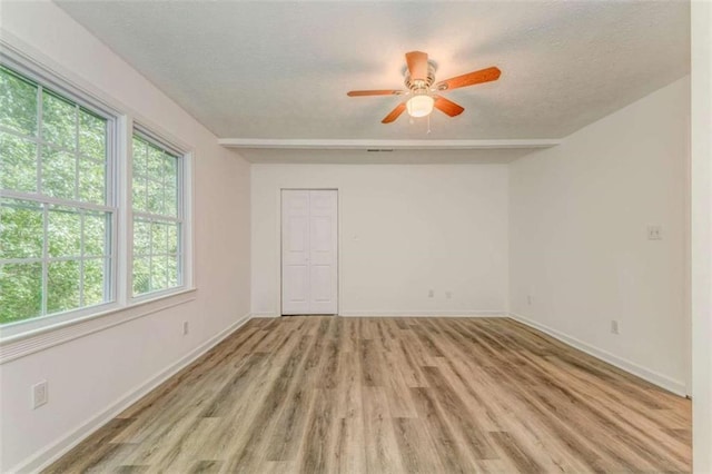 53 Knight Dr, Cedartown, GA 30125 - unfurnished room featuring healthy amount of natural light, light wood-type flooring, a ceiling fan, and a textured ceiling