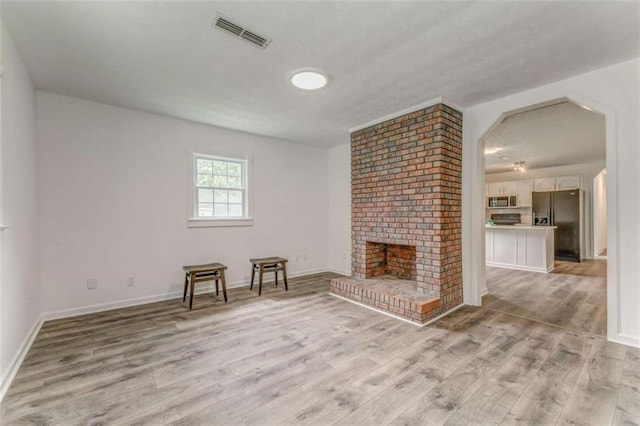53 Knight Dr, Cedartown, GA 30125 - unfurnished living room featuring light wood-style floors and a brick fireplace