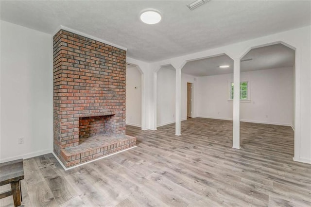 53 Knight Dr, Cedartown, GA 30125 - unfurnished living room with wood finished floors, a fireplace, and arched walkways