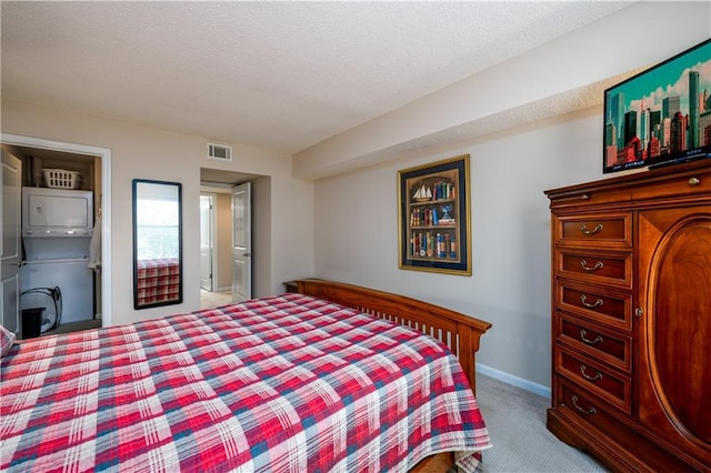 bedroom with light carpet and a textured ceiling