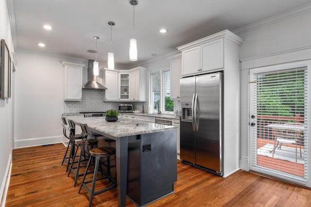 1038 Saint Charles Ave, Atlanta, GA 30306 - kitchen featuring stainless steel appliances, wall chimney exhaust hood, ornamental molding, a center island, and decorative backsplash