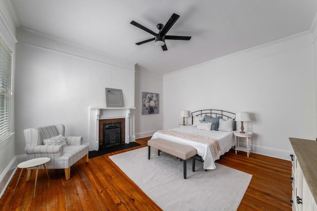 1038 Saint Charles Ave, Atlanta, GA 30306 - bedroom featuring ornamental molding, a tiled fireplace, dark wood-type flooring, baseboards, and ceiling fan