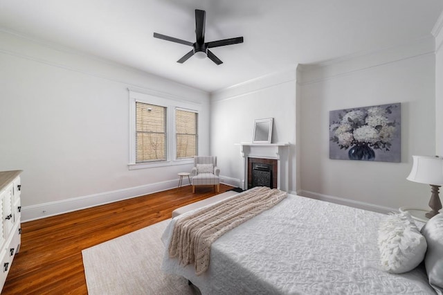 1038 Saint Charles Ave, Atlanta, GA 30306 - bedroom featuring wood finished floors, a fireplace, ornamental molding, baseboards, and a ceiling fan
