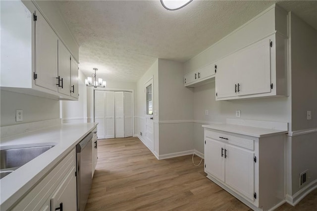 4732 Manly Ct, Stone Mountain, GA 30088 - kitchen with dishwasher, a chandelier, white cabinets, a textured ceiling, and light wood-style floors