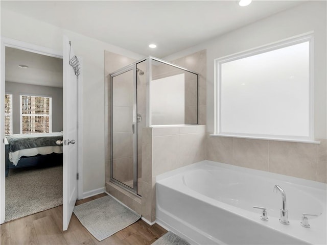 bathroom featuring hardwood / wood-style floors and shower with separate bathtub