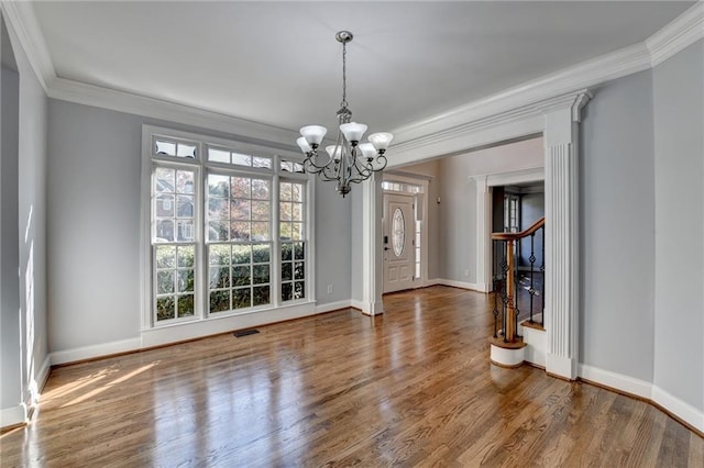 kitchen featuring crown molding, sink, black appliances, decorative light fixtures, and light hardwood / wood-style flooring