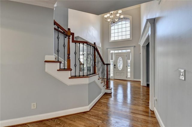 living room with crown molding, built in features, dark wood-type flooring, and a brick fireplace