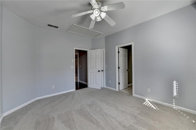 spare room featuring ceiling fan and light colored carpet