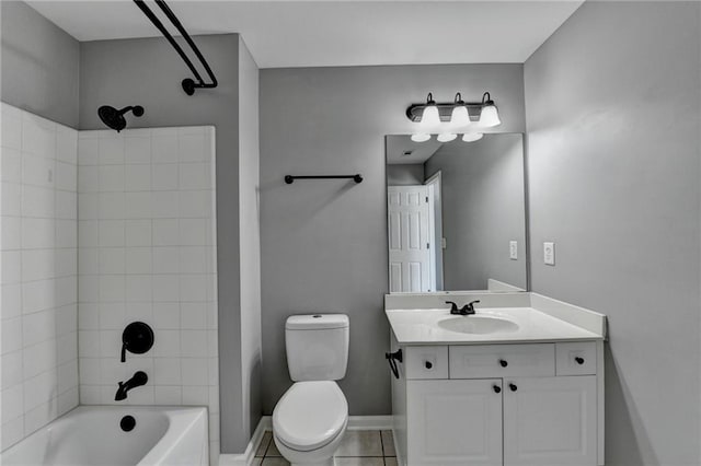 full bathroom with vanity, tile patterned floors, tiled shower / bath combo, and toilet