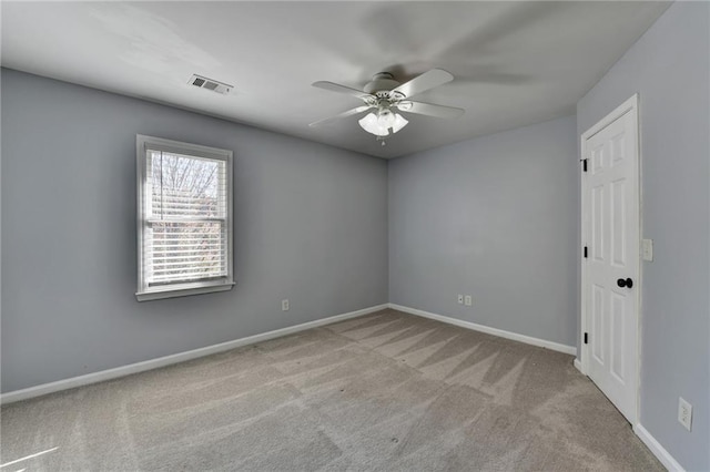 empty room featuring light carpet and ceiling fan