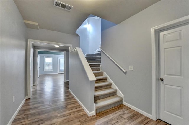 stairs with hardwood / wood-style flooring