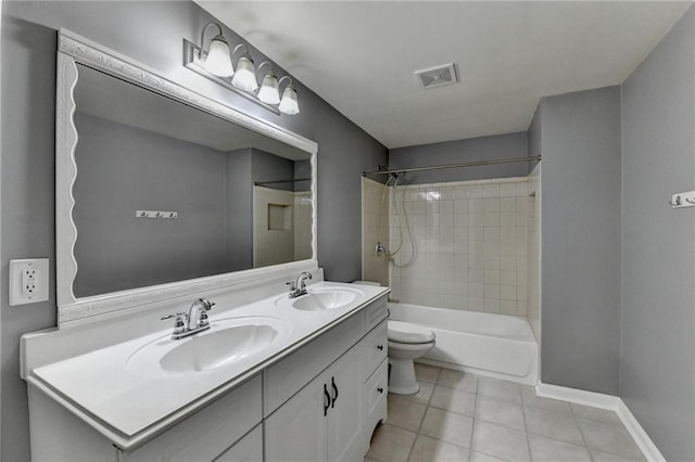 full bathroom with tile patterned floors, tiled shower / bath combo, toilet, and vanity