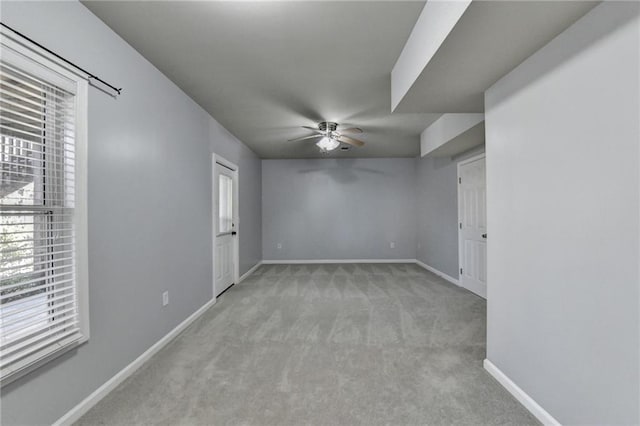 spare room featuring light carpet and ceiling fan