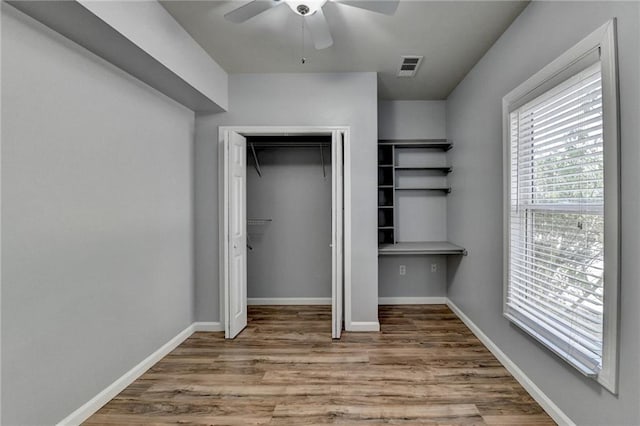 unfurnished bedroom with light wood-type flooring, a closet, and ceiling fan