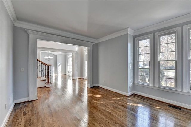 stairs featuring crown molding, hardwood / wood-style floors, and a high ceiling