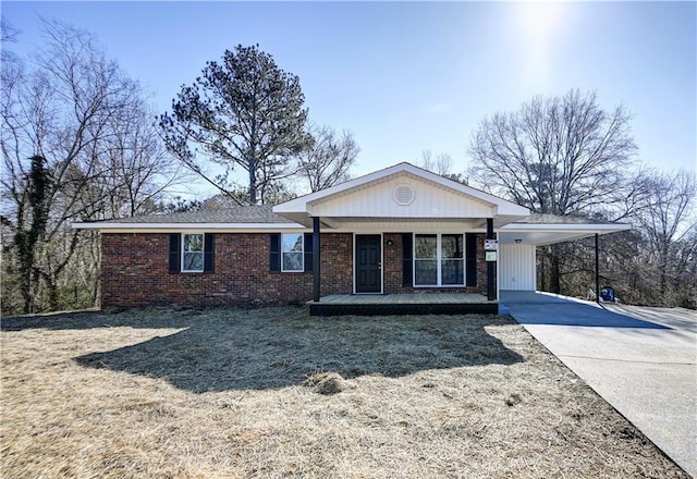 ranch-style house with a front yard, a carport, and a porch