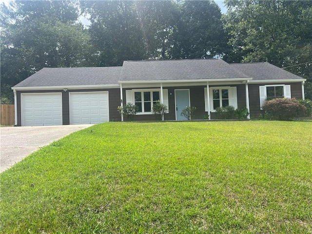 ranch-style home with a front lawn and a garage