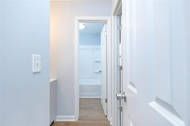 corridor featuring light hardwood / wood-style floors