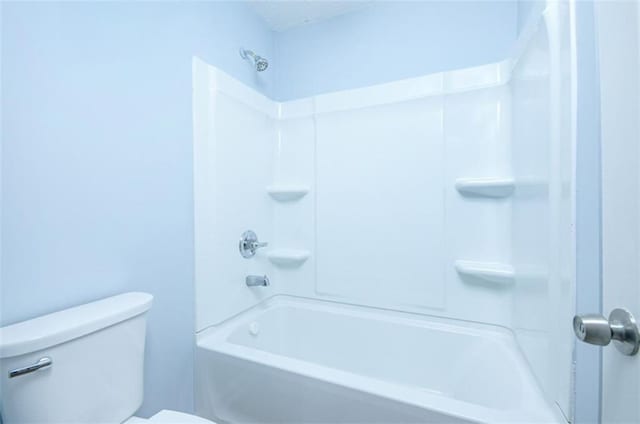 bathroom featuring toilet and bathing tub / shower combination