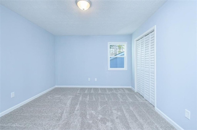 unfurnished bedroom with carpet flooring and a textured ceiling