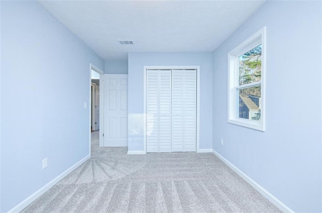 unfurnished bedroom with a closet and carpet floors