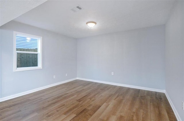 empty room with wood-type flooring