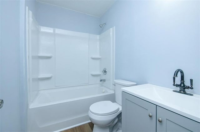 full bathroom featuring toilet, vanity,  shower combination, and hardwood / wood-style flooring