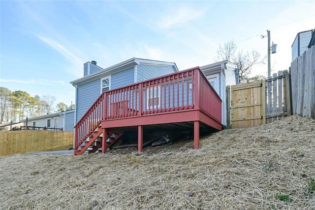 back of property featuring a wooden deck