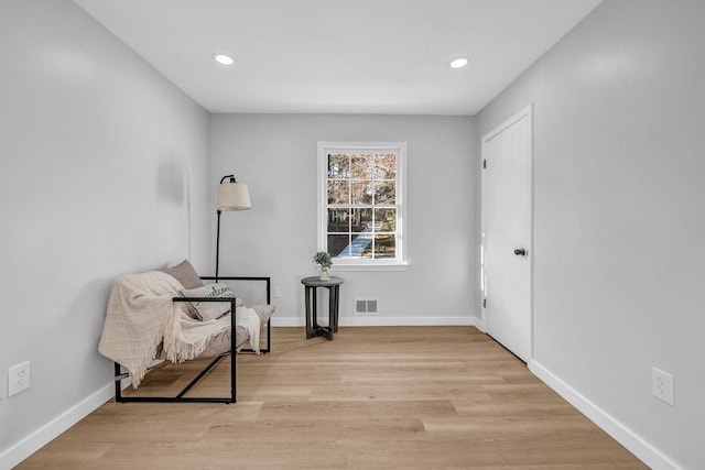 sitting room featuring recessed lighting, wood finished floors, visible vents, and baseboards