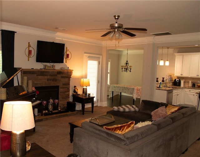 305 Anise Ct, Mcdonough, GA 30252 - carpeted living area featuring a sink, crown molding, ceiling fan, a stone fireplace, and a chandelier