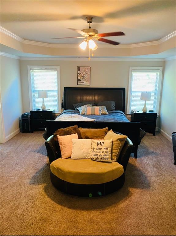 305 Anise Ct, Mcdonough, GA 30252 - bedroom with baseboards, ceiling fan, crown molding, and light colored carpet