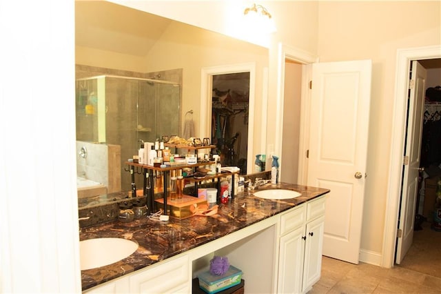305 Anise Ct, Mcdonough, GA 30252 - bathroom featuring a stall shower, a spacious closet, tile patterned flooring, and double vanity