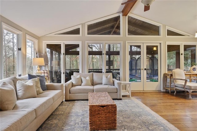 sunroom / solarium with ceiling fan and lofted ceiling with beams