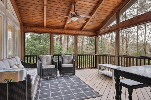 sunroom with vaulted ceiling with beams, ceiling fan, and wooden ceiling