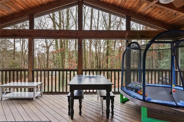 unfurnished sunroom featuring ceiling fan and lofted ceiling