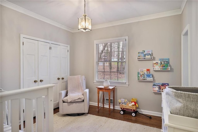 bedroom with hardwood / wood-style floors, ornamental molding, and a closet