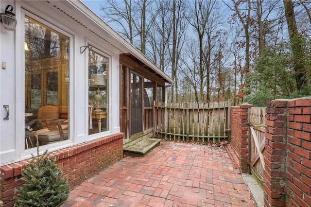 view of patio featuring a sunroom