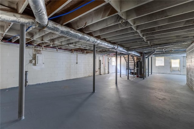 basement with water heater and electric panel