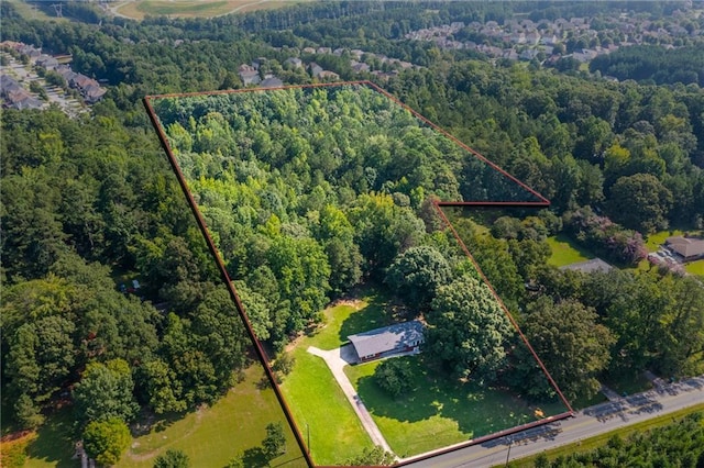 birds eye view of property with a wooded view