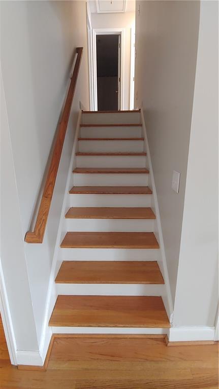 2477 Briar Valley Way, Dacula, GA 30019 - stairs with baseboards and wood finished floors