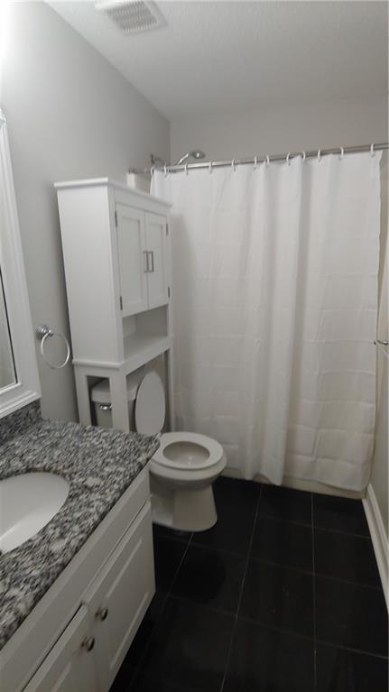 2477 Briar Valley Way, Dacula, GA 30019 - full bathroom with tile patterned flooring, vanity, toilet, a shower with curtain, and visible vents