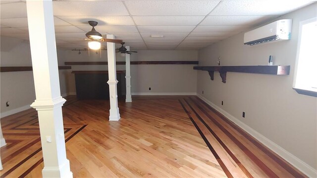 2477 Briar Valley Way, Dacula, GA 30019 - basement featuring baseboards, a wall mounted air conditioner, ceiling fan, a drop ceiling, and light wood-type flooring