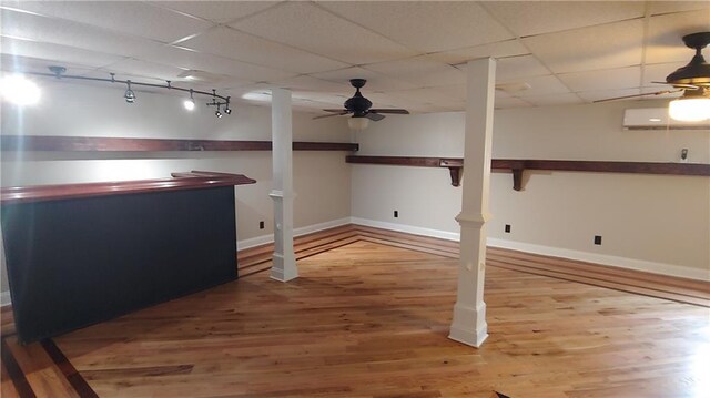 2477 Briar Valley Way, Dacula, GA 30019 - finished basement with a paneled ceiling, baseboards, a wall unit AC, wood finished floors, and a bar