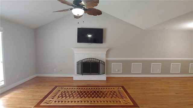 2477 Briar Valley Way, Dacula, GA 30019 - unfurnished living room with a ceiling fan, vaulted ceiling, light wood-type flooring, and a brick fireplace
