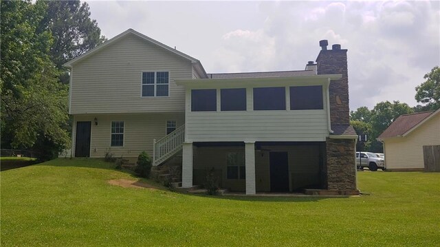 2477 Briar Valley Way, Dacula, GA 30019 - rear view of house with a lawn, stairs, a chimney, and stone siding