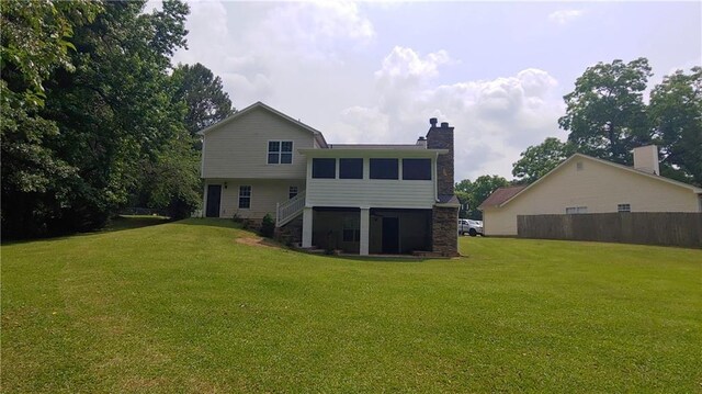 2477 Briar Valley Way, Dacula, GA 30019 - back of house with a lawn, a chimney, and stairway