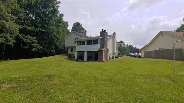 2477 Briar Valley Way, Dacula, GA 30019 - back of property featuring a lawn and a chimney