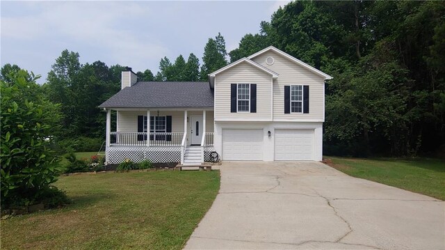 2477 Briar Valley Way, Dacula, GA 30019 - tri-level home with a garage, a front lawn, covered porch, and concrete driveway